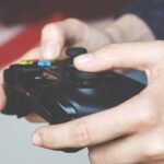 Un uomo con un pad della Xbox tra le mani